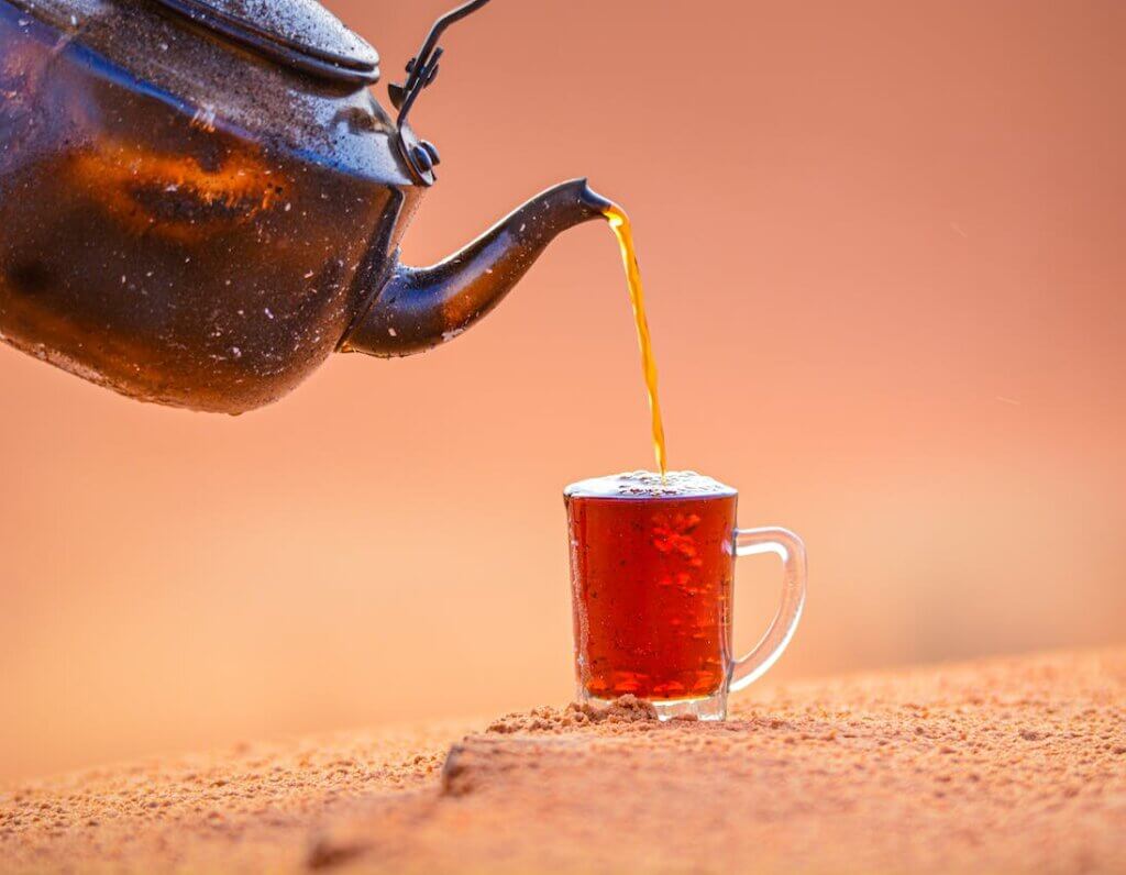 Brass kettle pouring Kashmiri Kahwa chai